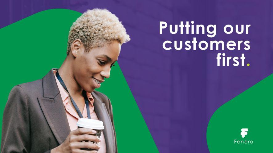 A professional promotional image for Fenero featuring a smiling woman with short, curly blonde hair wearing a blazer and a lanyard while holding a takeaway coffee cup. The background includes bold green and purple geometric shapes. The text on the image reads: "Putting our customers first." The Fenero logo is positioned in the lower right corner.